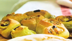 Jamie Oliver’s homemade twister bread with black olives, cheddar cheese and green pesto on ...