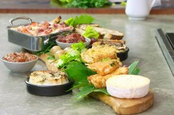 James Martin hot and cold cheese platter with vine leaves and grapes on James Martin’s Islands T ...