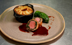 Tom Kitchin’s stuffed saddle of lamb served with braised lettuce and boulangere potatoes cooked  ...