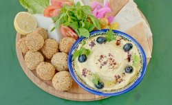 Ainsley Harriott herby falafels with homemade hummus, black olives and flatbread on Ainsley̵ ...