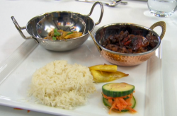 Judy Love’s Jamaican  chicken curry and brown stew chicken with rice, cucumber and plantai ...