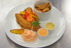 Judi Love’s fried tilapia fish with chips vegetables, mayonnaise,  coleslaw and plantains  ...