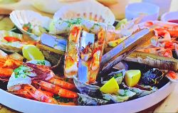 Tom Kerridge’s BBQ seafood platter with Japanese seaweed butter, spicy Mediterranean butte ...