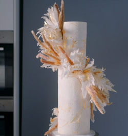 Nastassja Lusengo two tier wedding cake with Madeira sponge, buttercream and edible feathers on  ...