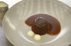Steph’s sticky toffee pudding with miso caramel sauce, poached apples and a vanilla custar ...